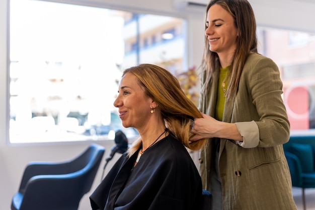 cheerful female hairstylist working with client salon 776325 631